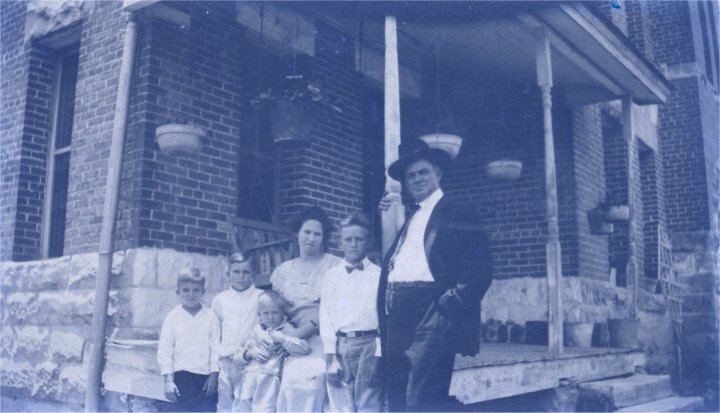 Robert M. Hudson and family in front of jailhouse