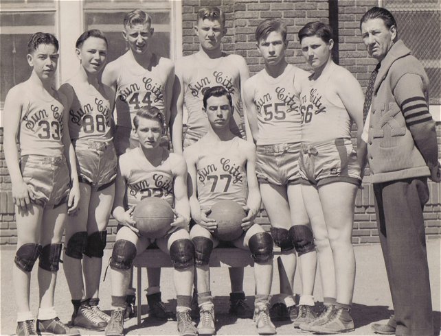 Sun City Basketball Team, 1938 or 1939, Sun City, Barber County, Kansas.

Front row, L-R: the two seniors, Ellis Bruch and Arly Kaminiski.

Back Row, L-R: Tommy Cornthwaite, Mead Adams, J.R. Massey, Mark McLain, Ernest Keller, Junior Fittro, Coach McCoy (full blooded Cherokee from Okla).

Photo courtesy of Brenda McLain.