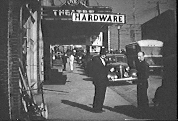 Unknown men standing in front of Hardware Store