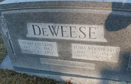 Close-up of a tombstone with a statue

AI-generated content may be incorrect.