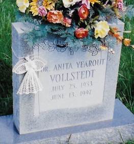 A tombstone with flowers on it

Description automatically generated with low confidence